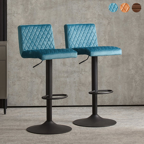 A pair of Ainpecca bar stools with velvet upholstery and diamond stitch design