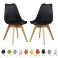 Set of 2 black retro dining chairs with cushioned seats and wooden legs