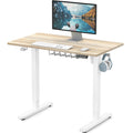 SHW Small Electric Height Adjustable Sit Stand Desk with white frame and maple top, featuring hanging hooks and cable managem