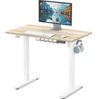 SHW Small Electric Height Adjustable Sit Stand Desk with white frame and maple top, featuring hanging hooks and cable managem