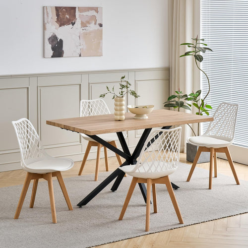 Modern dining table with black legs and four chairs with mesh polypropylene backrests