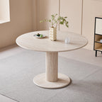 Round dining table with faux marble top and cylindrical metal legs in a modern minimalist style