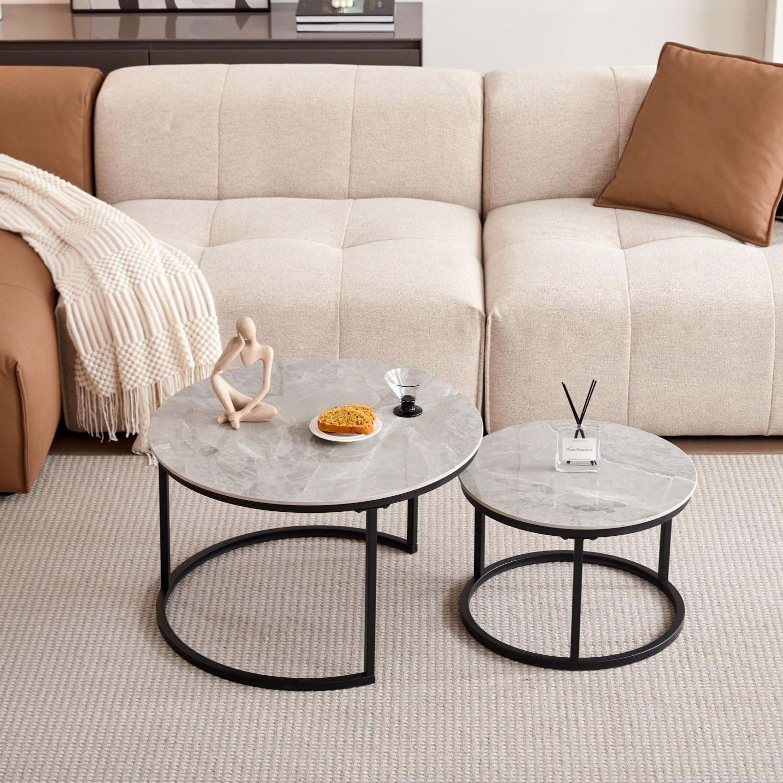 Round coffee table with grey marble top and black metal frame