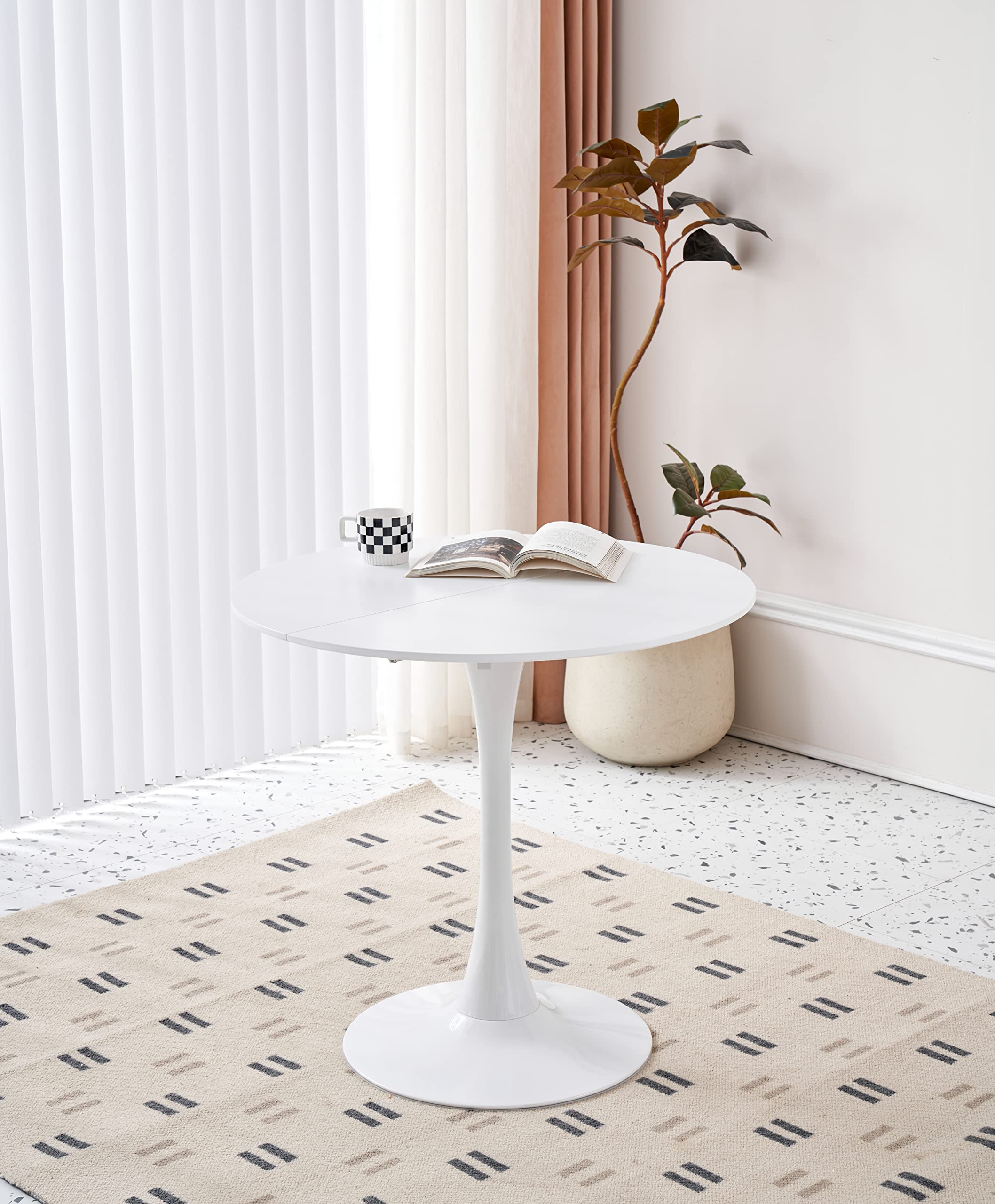 Elegant white round dining table with a pedestal base and a smooth engineered wood top