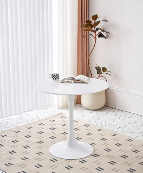 Elegant white round dining table with a pedestal base and a smooth engineered wood top