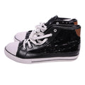 Black high-top sneakers with white laces on a light gray background